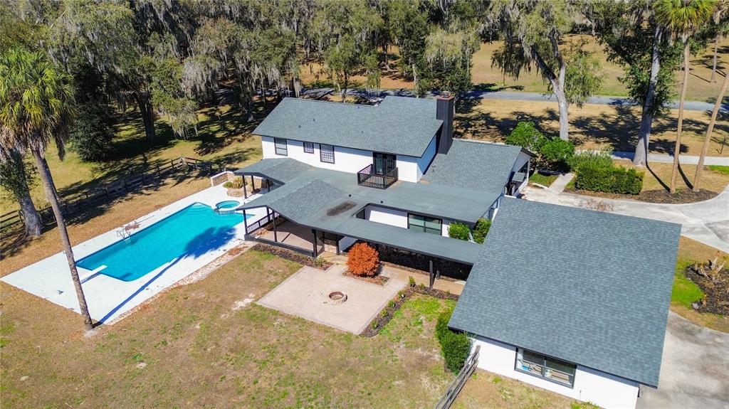 An aerial view of a two-story house with a swimming pool and a large patio — 3575 SW 24TH AVENUE ROAD, OCALA, FL