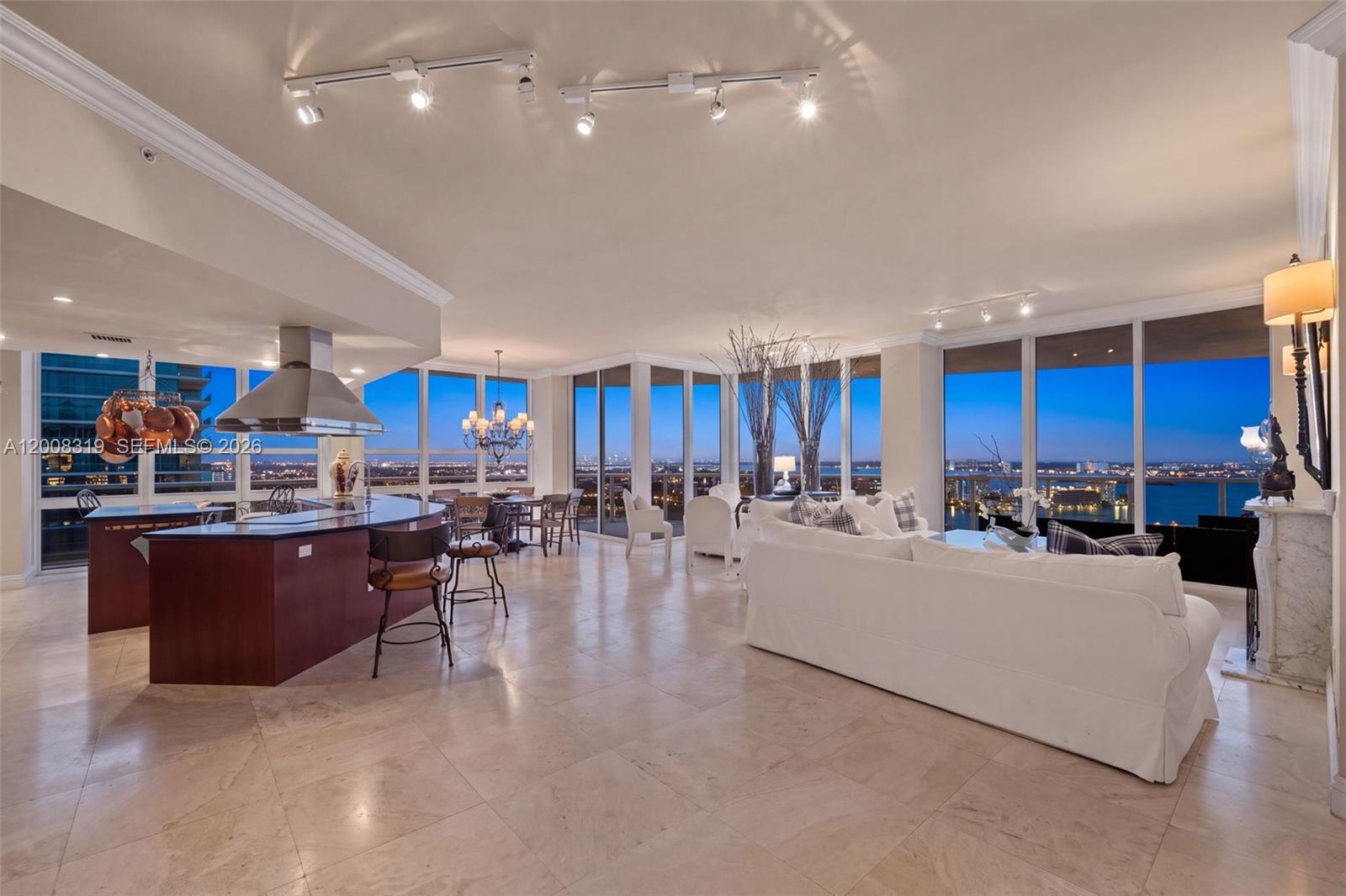 An open-concept living and kitchen area features tile floors, floor-to-ceiling windows, and city views — 10225 Collins Ave # 2004, Bal Harbour FL 33154, BAL HARBOUR, FL