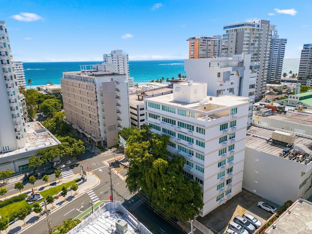 An aerial view of a multi-story apartment building near the ocean in a city — 57 ASHFORD AVENUE UNIT 5, SAN JUAN, PR