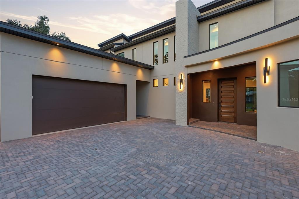 A modern two-story house exterior features a paved driveway, a garage, and a recessed entrance — 1615 COLE ROAD, ORLANDO, FL