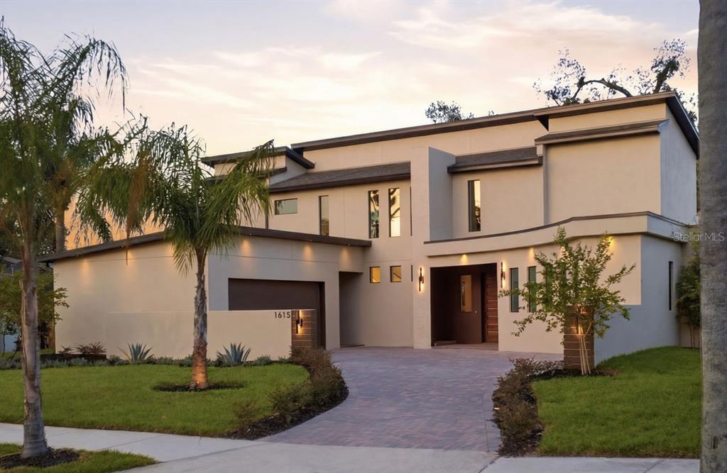 A modern two-story house with a paved driveway, palm trees, and a flat roof — 1615 COLE ROAD, ORLANDO, FL