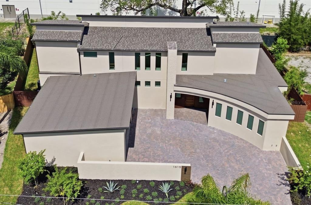 An aerial view of a modern house with a paved driveway and a flat roof — 1615 COLE ROAD, ORLANDO, FL