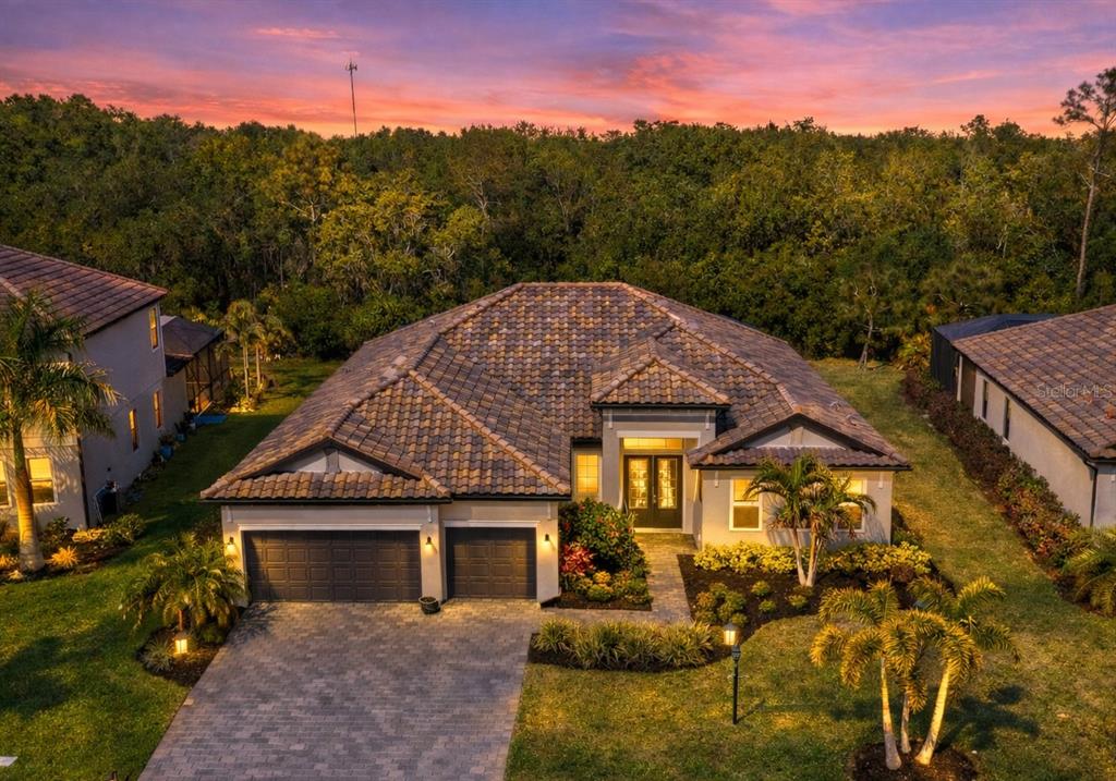 An aerial view of a single-story house with a tile roof and a paved driveway — 16309 TRADEWIND TERRACE, LAKEWOOD RANCH, FL