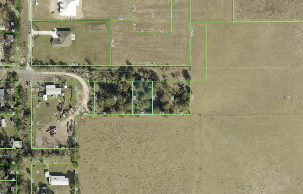 This is an aerial map showing several rectangular land parcels outlined in green — EVENING STAR UNIT 00, BROOKSVILLE, FL