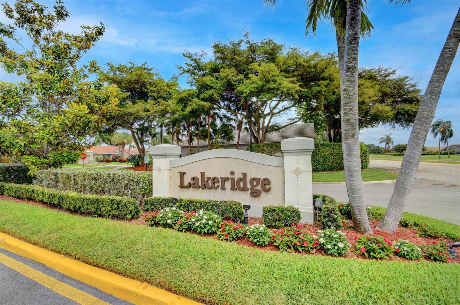 An entryway features white walls, dark wood-look flooring, a front door, and a closet — 6157 Bay Isles Drive, Boynton Beach FL 33437, BOYNTON BEACH, FL
