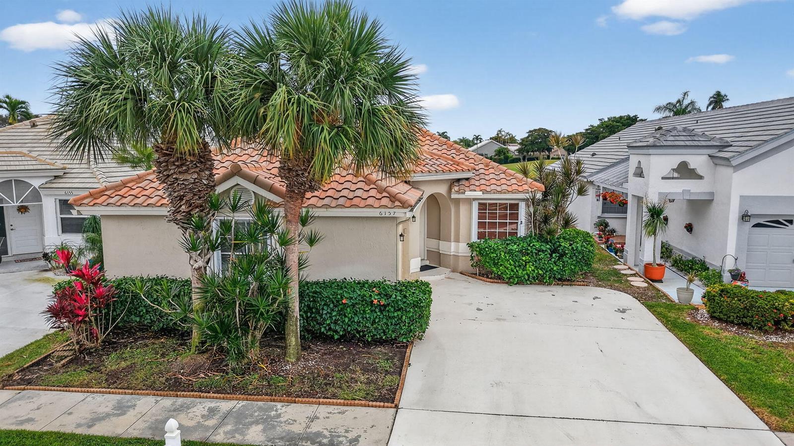 A kitchen with white cabinets, stainless steel appliances, a central island, and dark wood flooring — 6157 Bay Isles Drive, Boynton Beach FL 33437, BOYNTON BEACH, FL