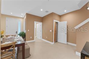 A dining area features a wooden table, chairs, and doorways leading to other rooms — 3175 BRASILIA AVENUE, KISSIMMEE, FL