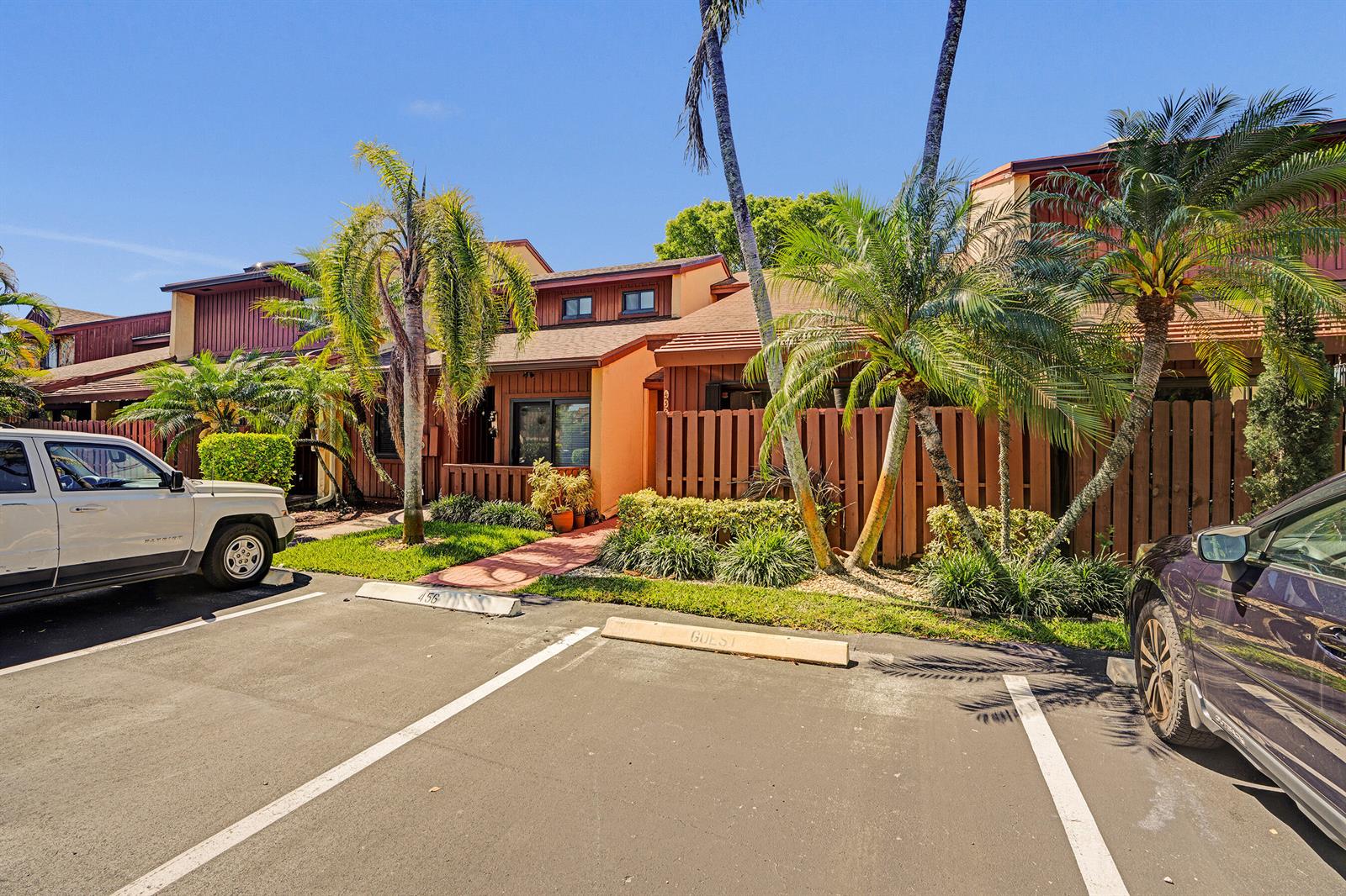 A parking lot sits in front of a multi-story townhouse complex with palm trees — 456 SE 14th Street, Dania Beach FL 33004, DANIA BEACH, FL