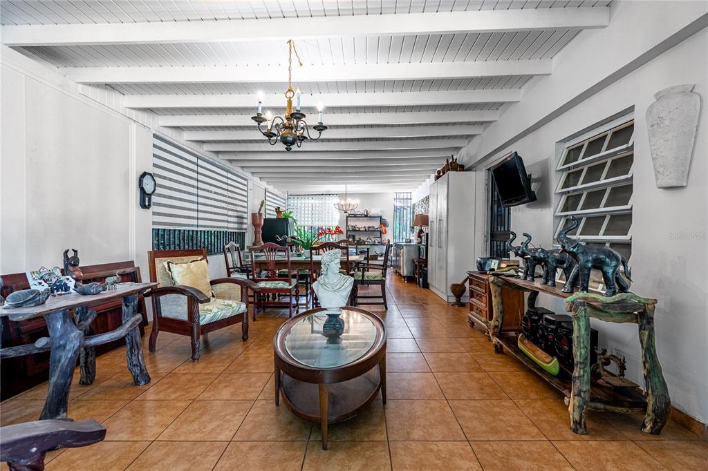 A spacious room with tiled floors, exposed white ceiling beams, and a dining area — SR 310 km 0.8 LAS QUEBRADAS , HACIENDA TRES CASITAS, CABO ROJO, PR