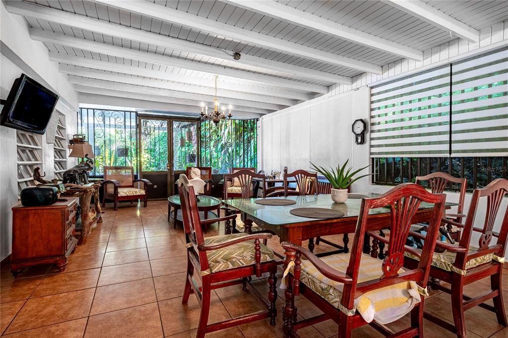 A dining room features a wooden table, chairs, tile flooring, and a white beamed ceiling — SR 310 km 0.8 LAS QUEBRADAS , HACIENDA TRES CASITAS, CABO ROJO, PR
