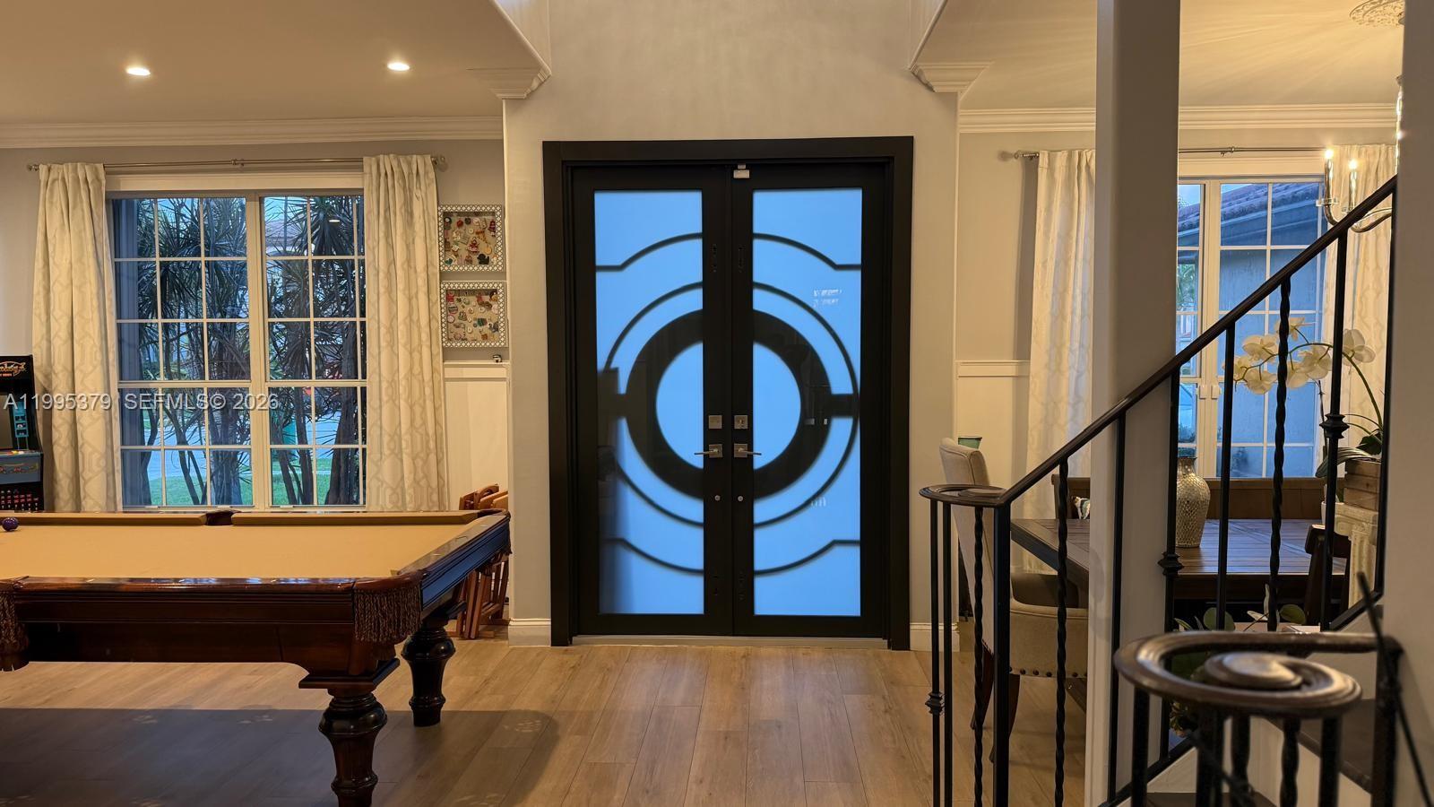A foyer features a pool table, a black double door with geometric glass, and a staircase — 2386 SW 183rd Ter, Miramar FL 33029, MIRAMAR, FL