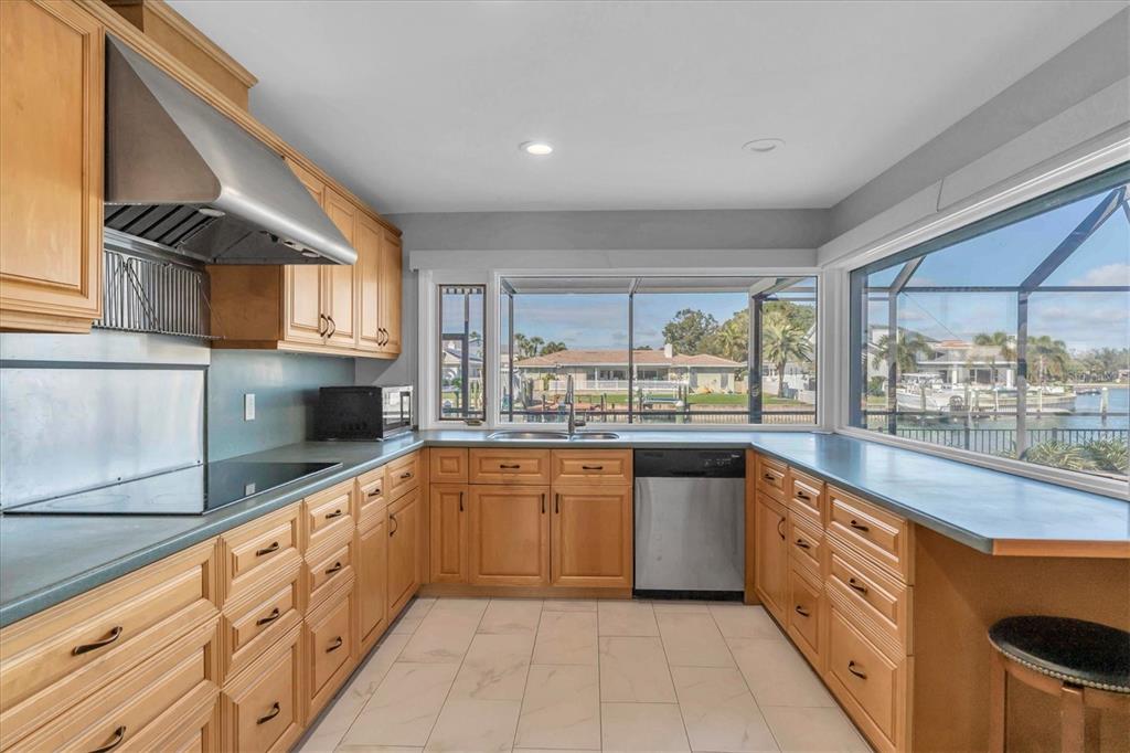A kitchen with light wood cabinets, a stainless steel range hood, and a waterfront view — 4935 62ND AVENUE S, ST PETERSBURG, FL