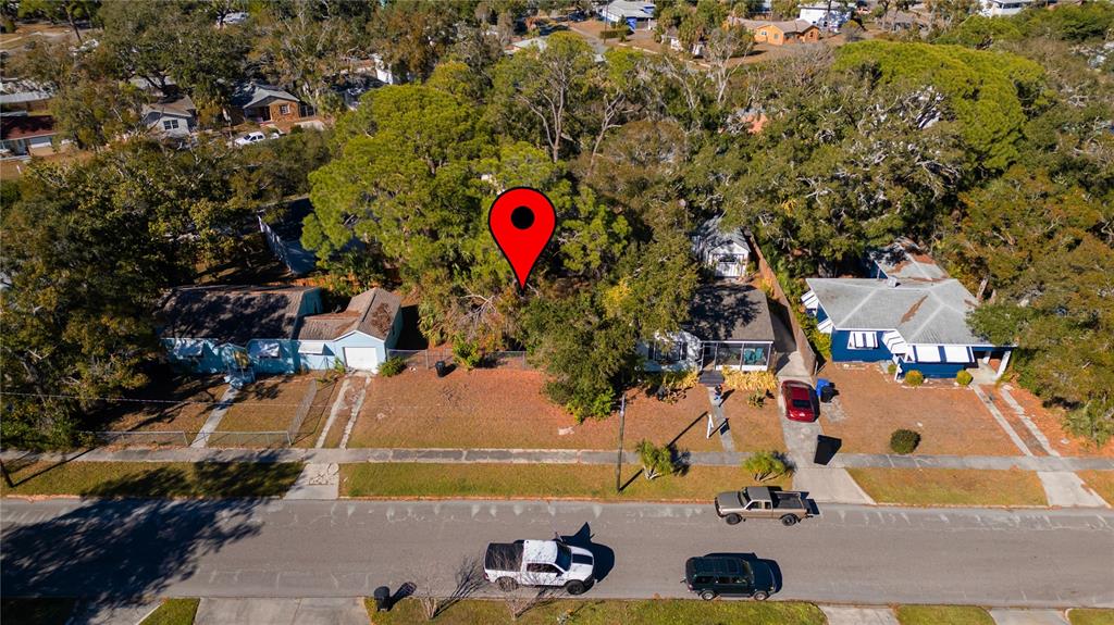 An aerial view shows a vacant residential lot situated between two houses on a street — 26TH AVENUE S, ST PETERSBURG, FL
