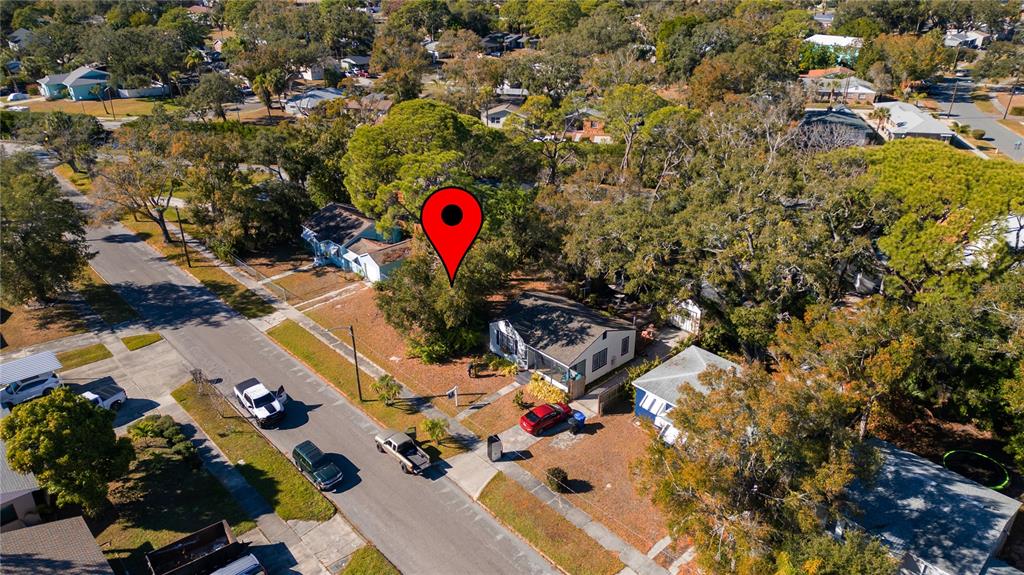 An aerial view shows a residential street with houses, trees, and a red location pin — 26TH AVENUE S, ST PETERSBURG, FL