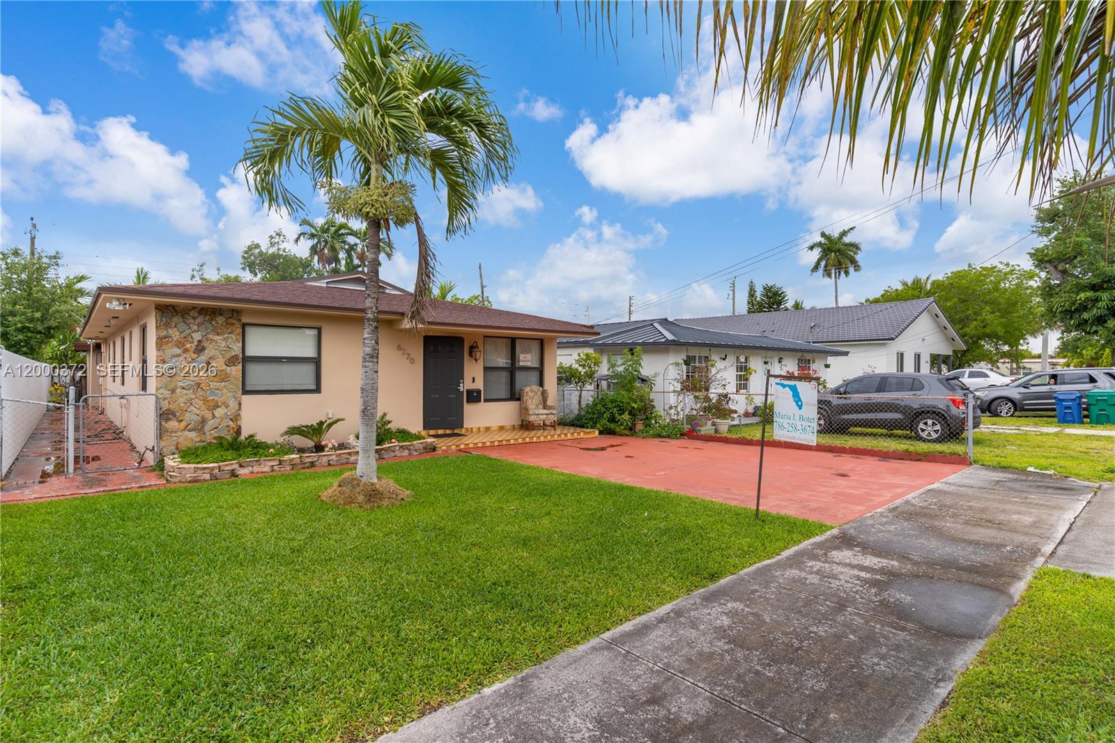 A single-story house with a stone facade, a palm tree, and a red concrete driveway — 6770 SW 15th St, Miami FL 33144, MIAMI, FL