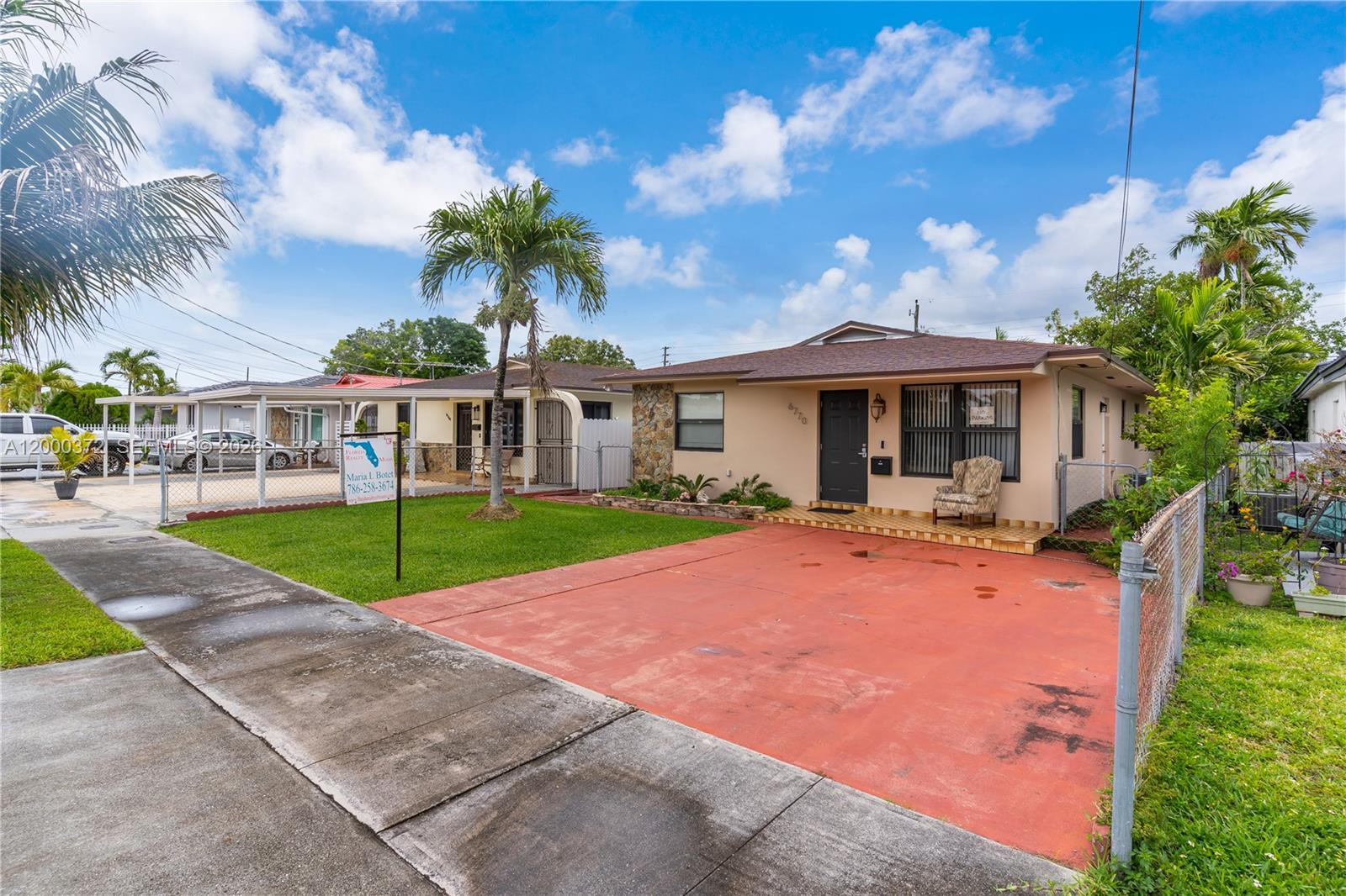A single-story house with a red concrete driveway, a front lawn, and a palm tree — 6770 SW 15th St, Miami FL 33144, MIAMI, FL