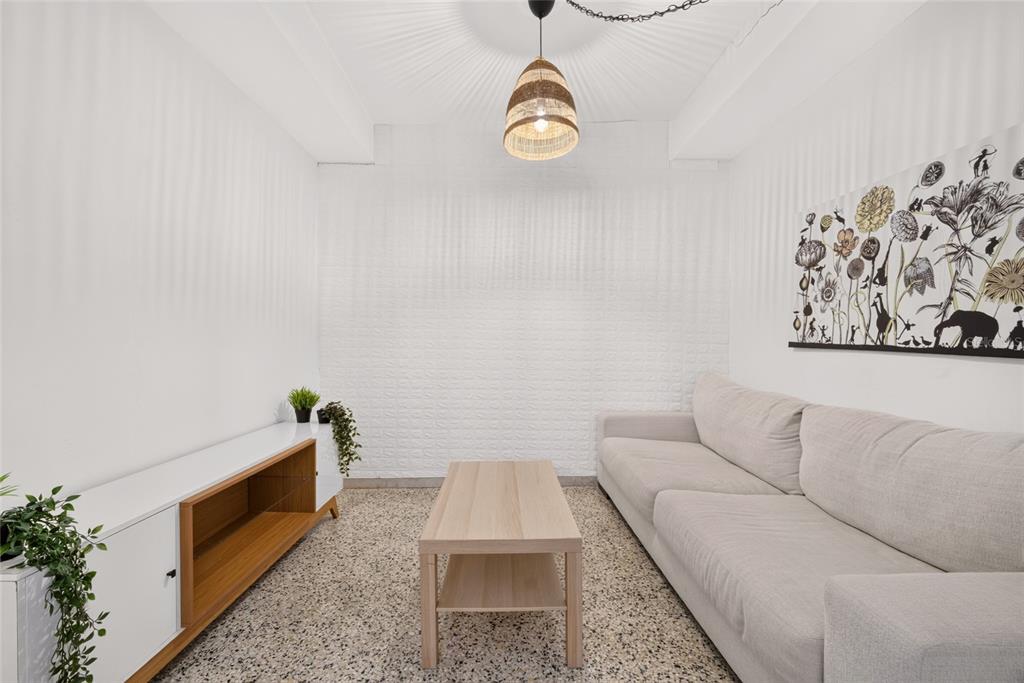 A living room features a beige sofa, a wooden coffee table, and a white media console — C10 CALLE 5, LUQUILLO, PR
