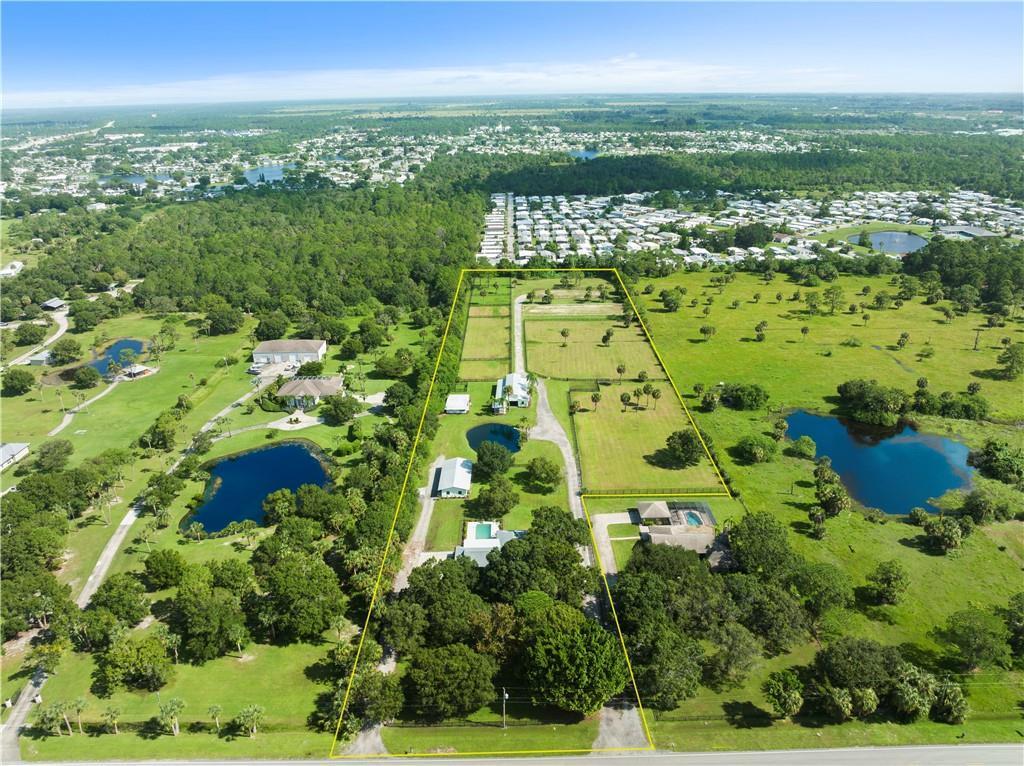 An aerial view shows a large rural property with multiple buildings, ponds, and fenced pastures — 8530 8th Street, Vero Beach FL 32968, VERO BEACH, FL