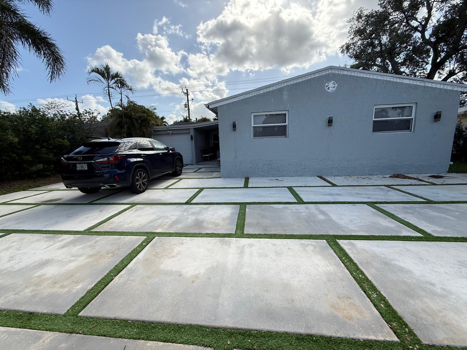 A single-story house with a large concrete paver driveway featuring artificial turf inlays — 3111 N 66th Avenue, Hollywood FL 33024, HOLLYWOOD, FL