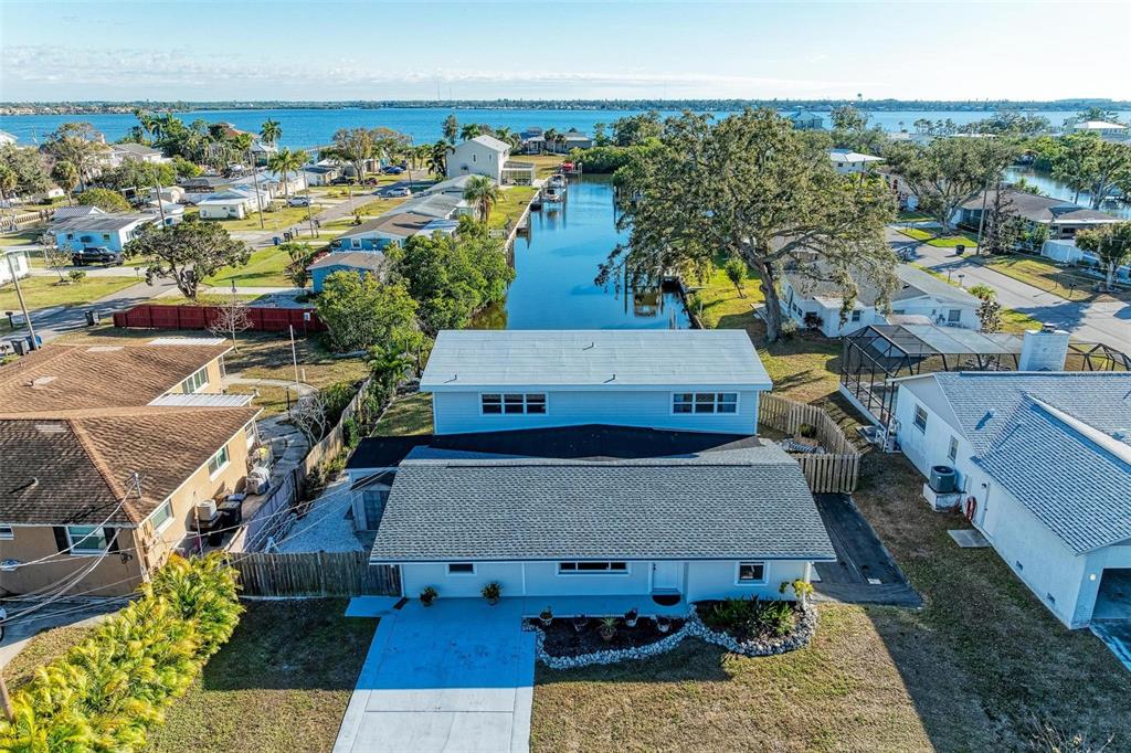 An aerial view shows a two-story house with a canal in the backyard — 3311 WATER STREET, ELLENTON, FL