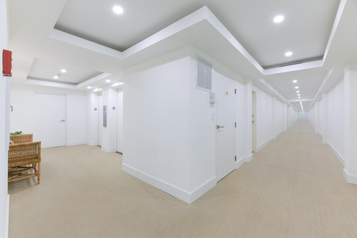 A bright, white hallway features recessed lighting, beige carpeting, and elevator access — 170 N Ocean Boulevard # 511, Palm Beach FL 33480, PALM BEACH, FL