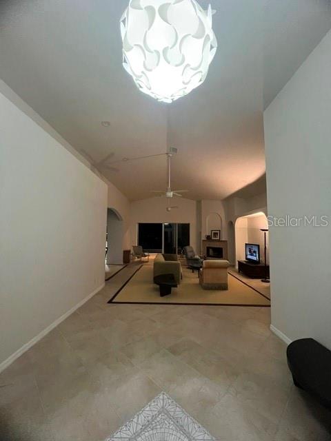 A living room features tile flooring, a large pendant light, and a fireplace — 15227 APPLETON BOULEVARD, PORT CHARLOTTE, FL