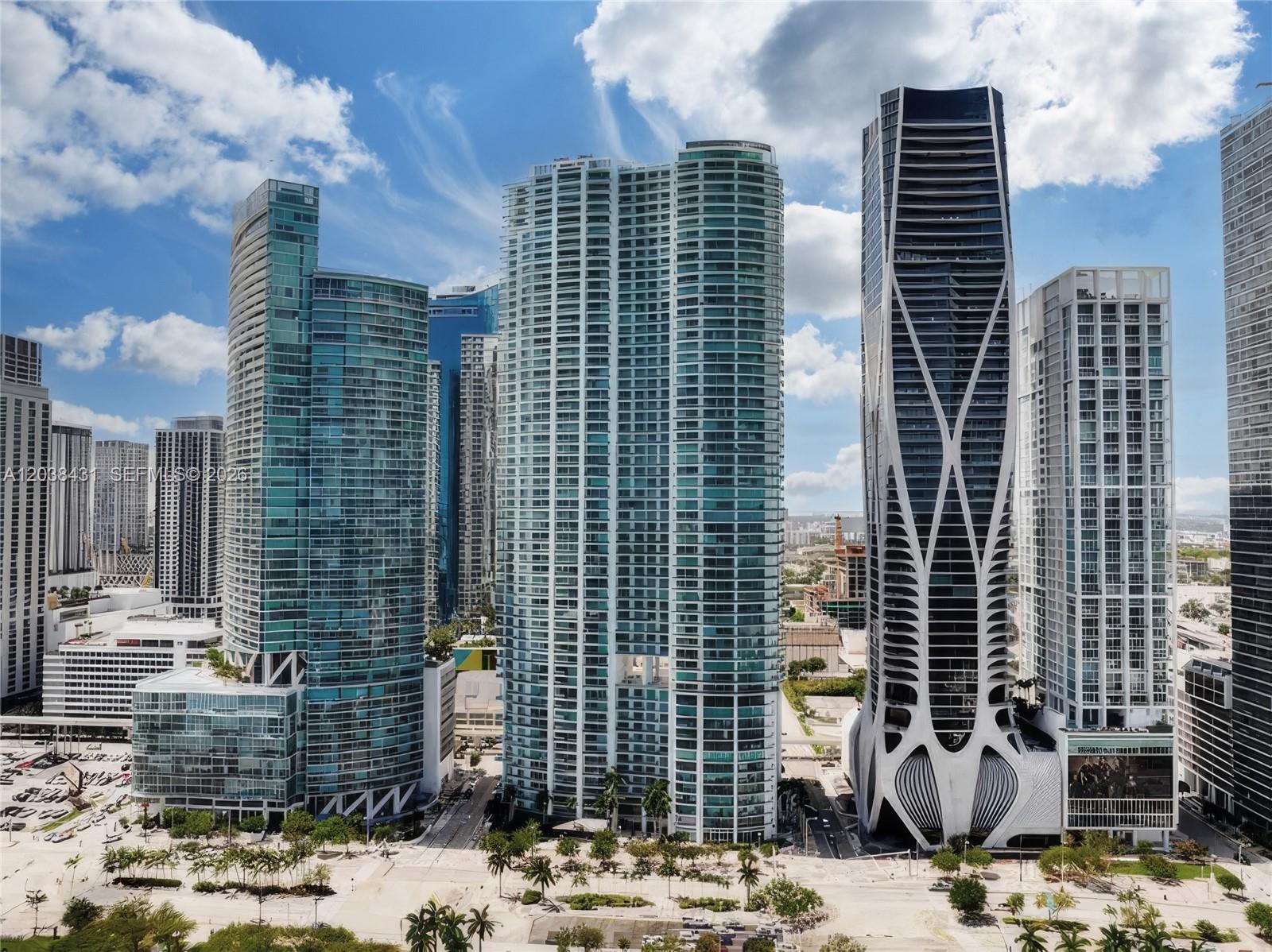 An aerial view of several modern glass skyscrapers in a dense urban city skyline — 900 Biscayne Blvd # 2302, Miami FL 33132, MIAMI, FL