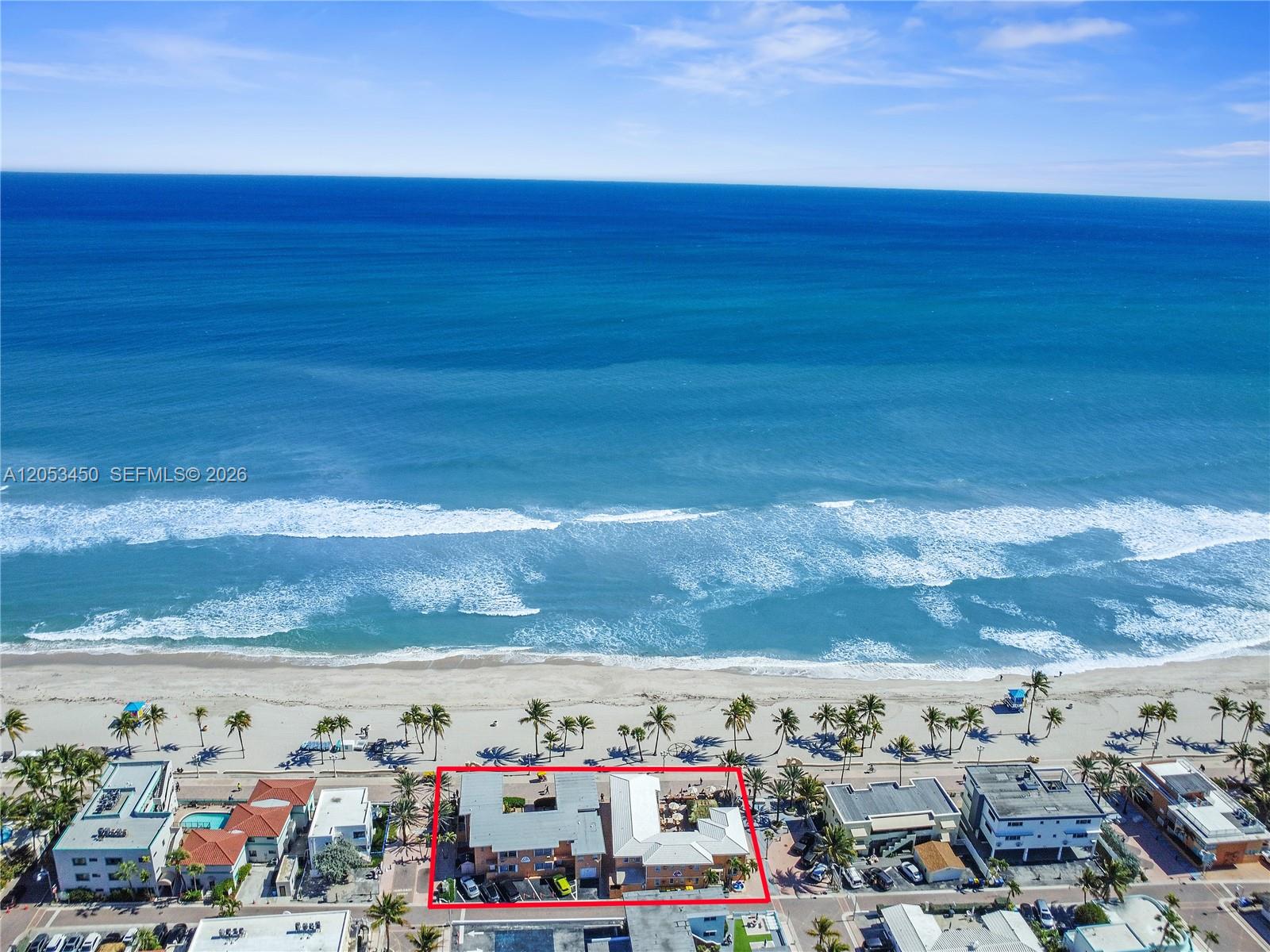 An aerial view shows a multi-story building outlined in red situated along a sandy beach — 2300-2325 N Surf Rd, Hollywood FL 33019, HOLLYWOOD, FL
