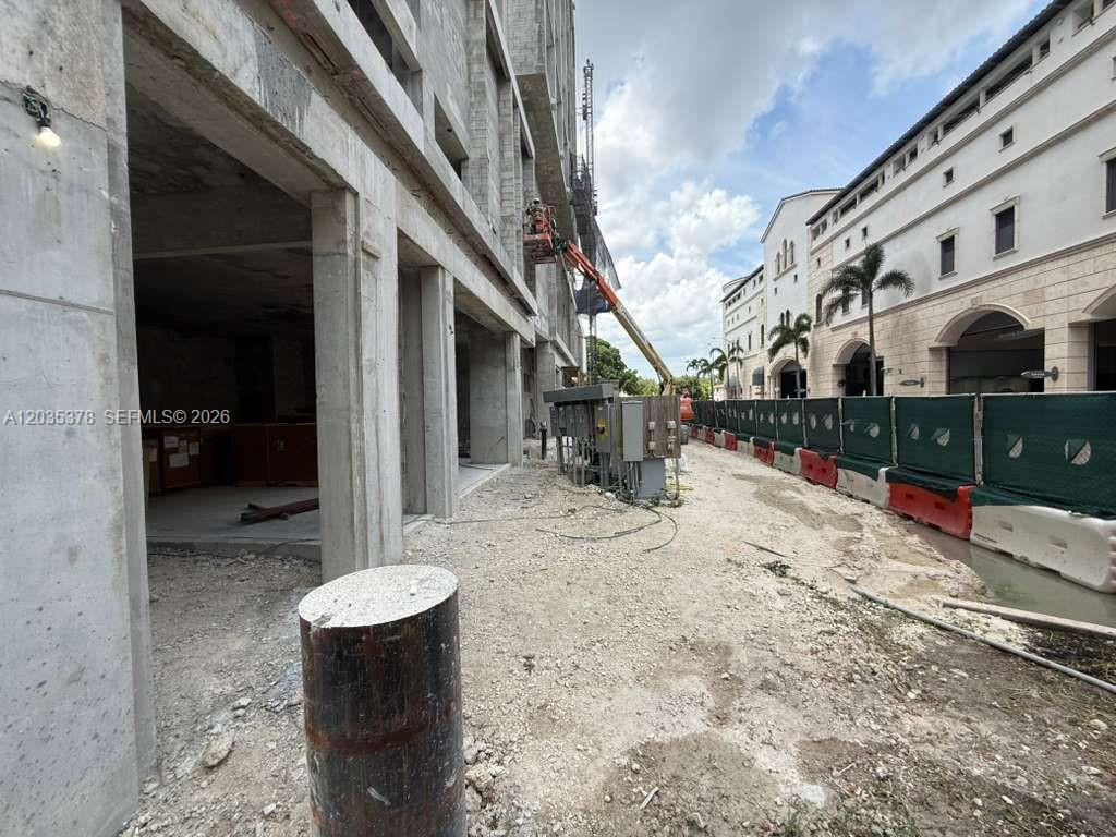 A construction site shows an unfinished concrete building next to a completed commercial structure — 4011 SALZEDO ST, FL 33146, FL