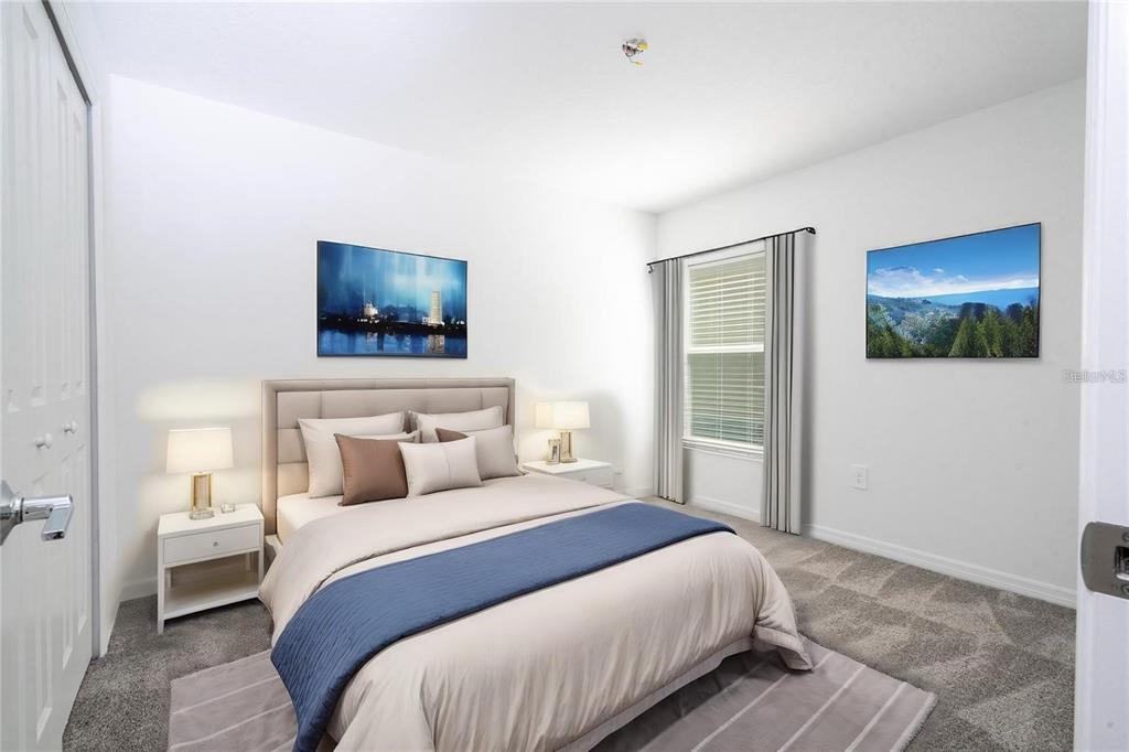 A bedroom features a bed with a blue runner, two nightstands, and two wall art pieces — 4278 GREEN GABLES PLACE, KISSIMMEE, FL