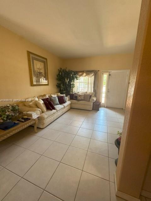 A living room features light-colored tile floors, a beige sofa, and a front entryway door — 18201 SW 144th Ct, Miami FL 33177, MIAMI, FL