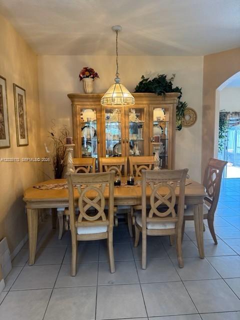 A dining room features a wooden table and chairs set before a large glass-fronted china cabinet — 18201 SW 144th Ct, Miami FL 33177, MIAMI, FL