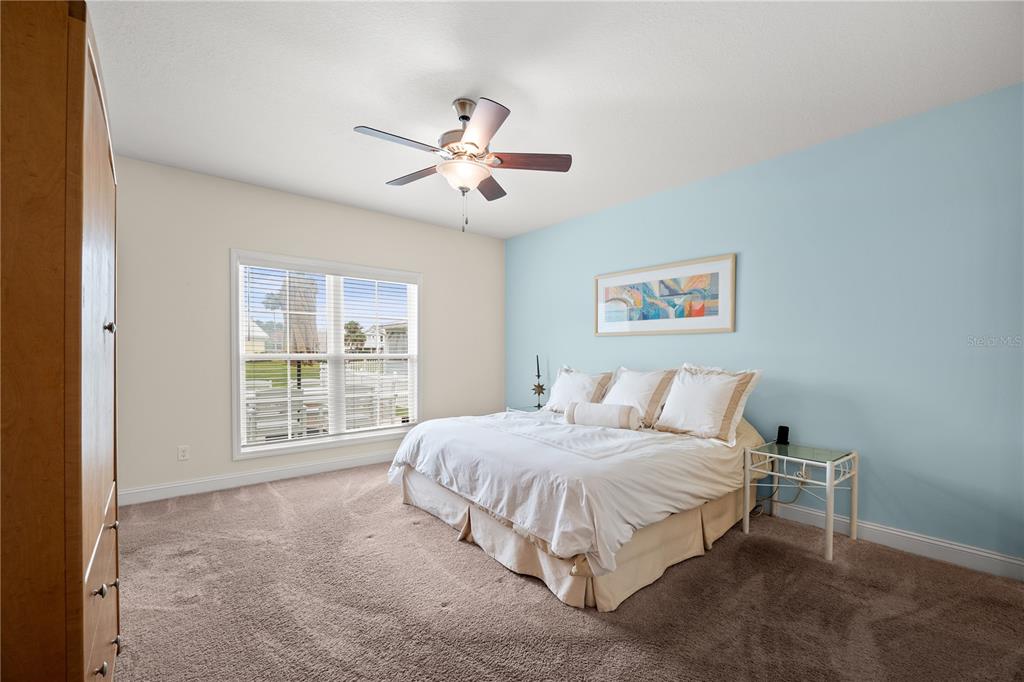 A kitchen features white cabinets, granite countertops, stainless steel appliances, and dark wood-look flooring — 101 YACHT CLUB POINT, GREEN COVE SPRINGS, FL