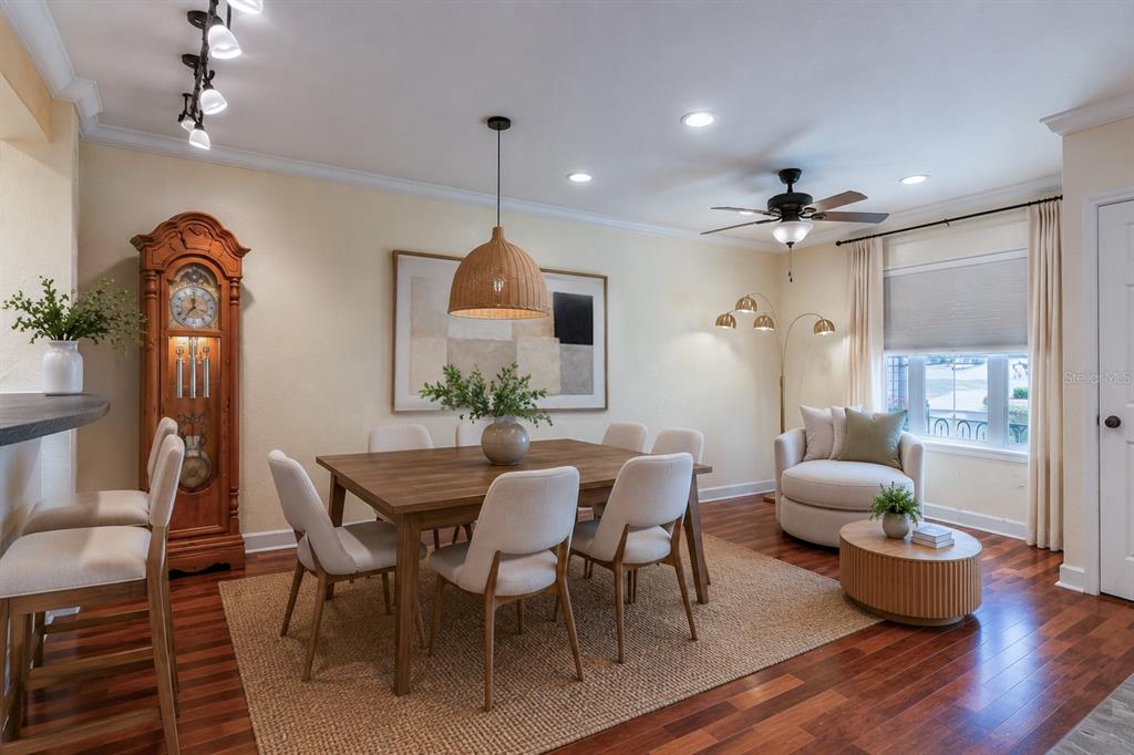 A dining room features a wooden table, six chairs, a grandfather clock, and a lounge area — 202 E SOUTH STREET UNIT 1044, ORLANDO, FL
