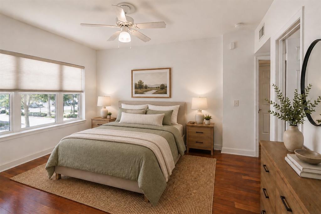 A bedroom features a queen bed, wooden nightstands, a dresser, and a ceiling fan — 202 E SOUTH STREET UNIT 1044, ORLANDO, FL