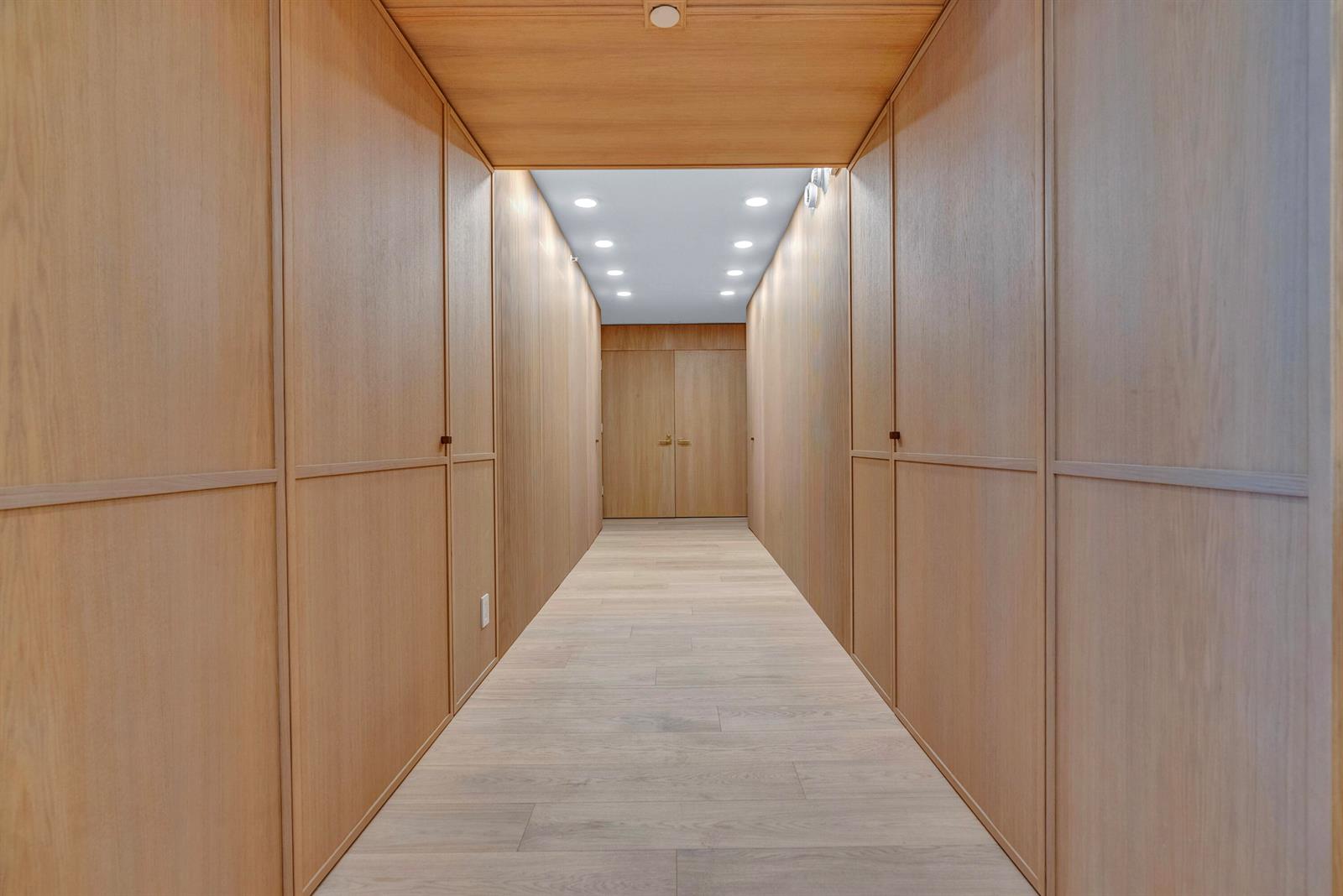 A hallway features light wood paneling on the walls and ceiling with recessed lighting — 3170 S Ocean Boulevard # N204, Palm Beach FL 33480, PALM BEACH, FL