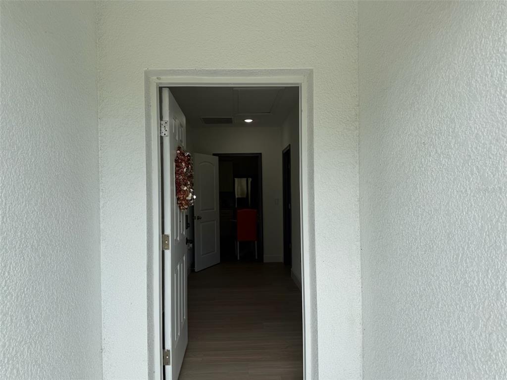 A view through an open doorway into a home interior with light-colored walls — 2050 FLORIDA DEVELOPMENT ROAD UNIT B, DAVENPORT, FL