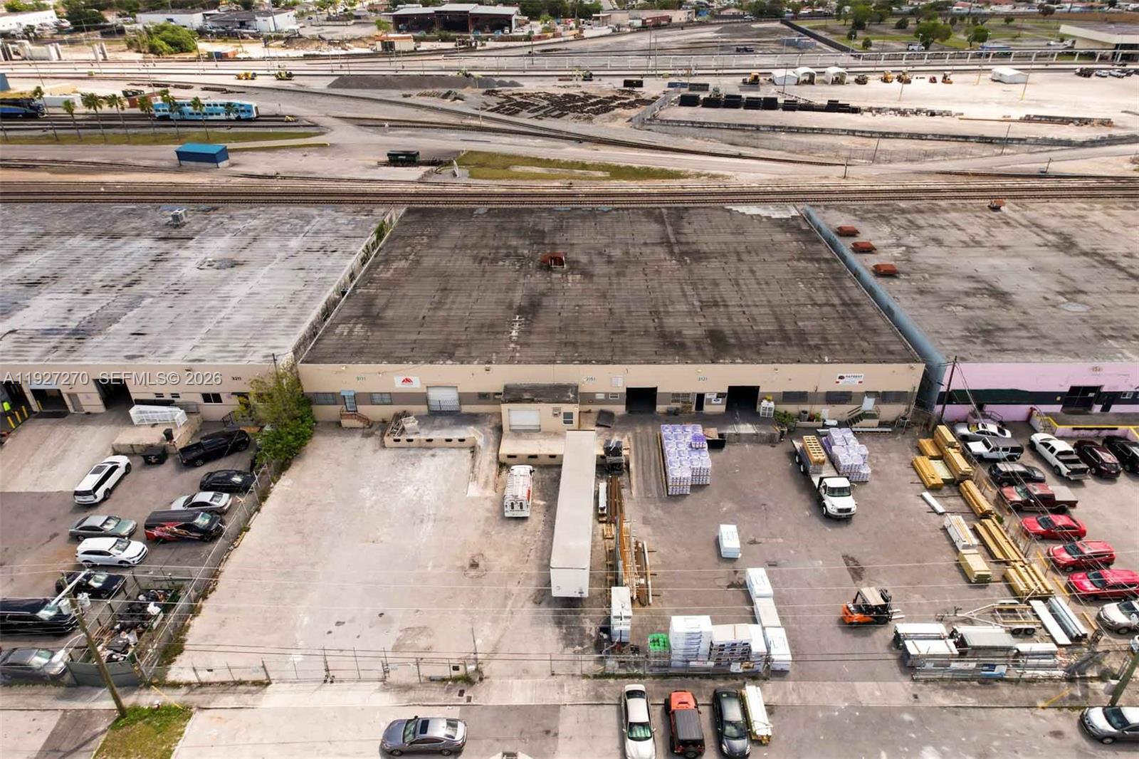 An aerial view shows a commercial warehouse building with a loading dock and parking lot — 3121 E 11th Ave # 3121, Hialeah FL 33013, HIALEAH, FL