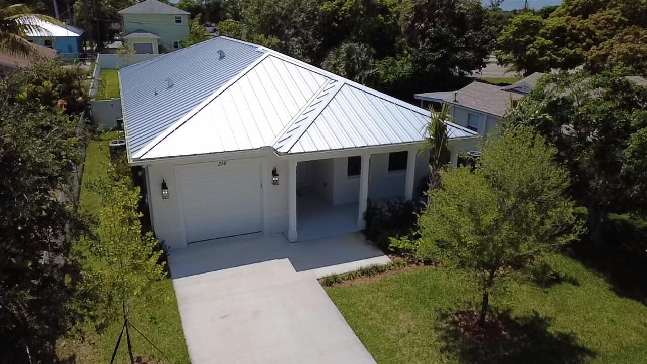 An aerial view of a single-story house with a white metal roof and garage — 316 SW 4th Avenue, Delray Beach FL 33444, DELRAY BEACH, FL