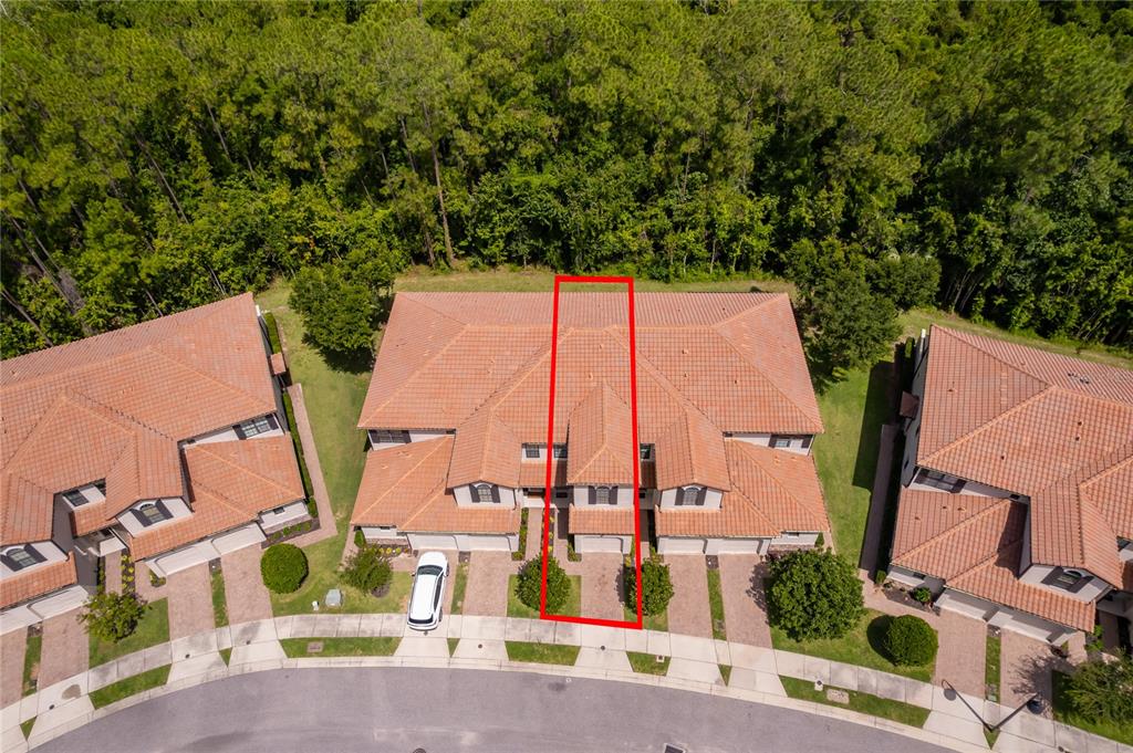 An aerial view shows a townhome unit highlighted in red within a suburban residential complex — 8213 ROSEVILLE BOULEVARD, DAVENPORT, FL