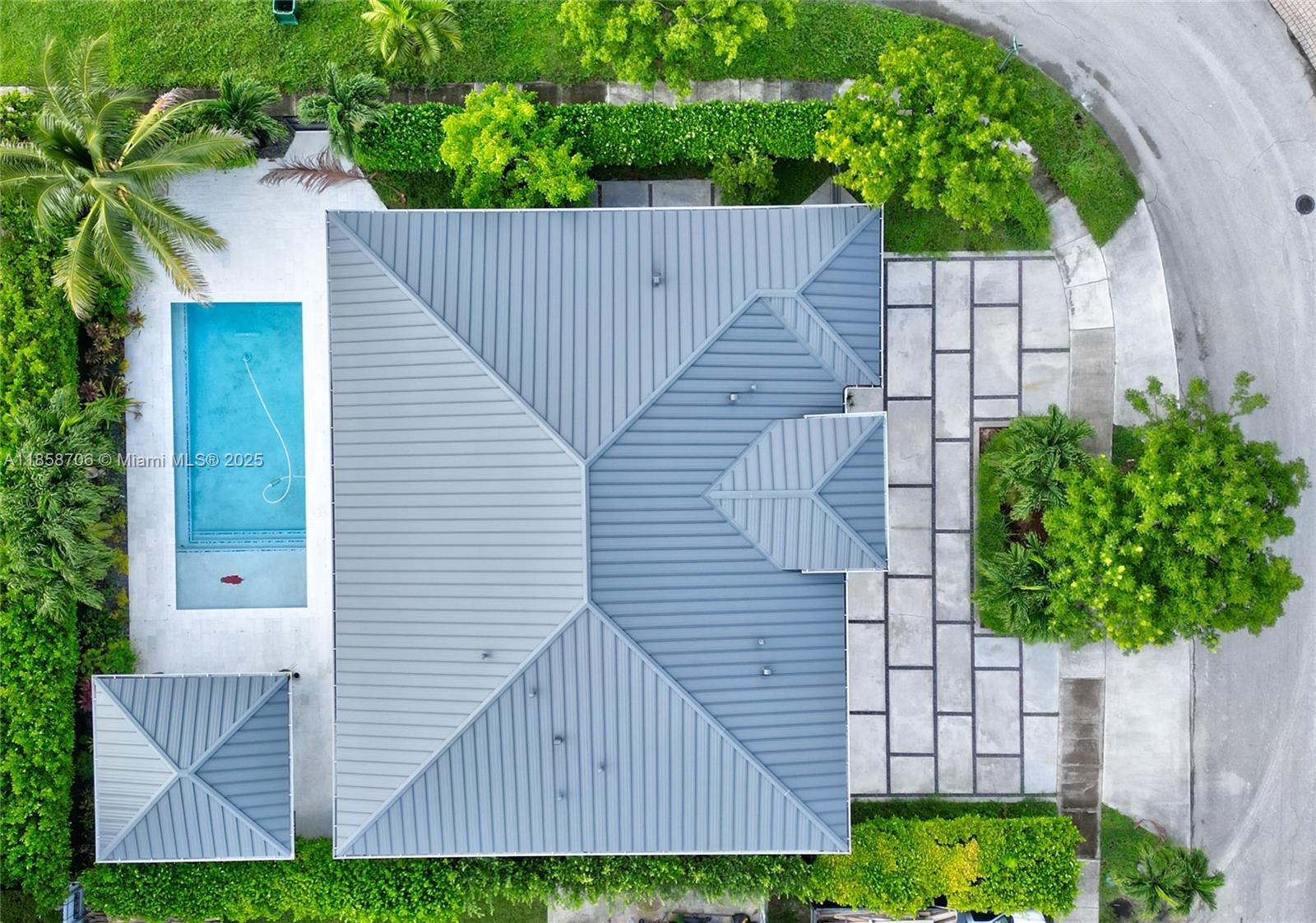 An aerial view shows a house with a metal roof, a pool, and a paved driveway — 2521 SW 105th Ave, Miami FL 33165, MIAMI, FL