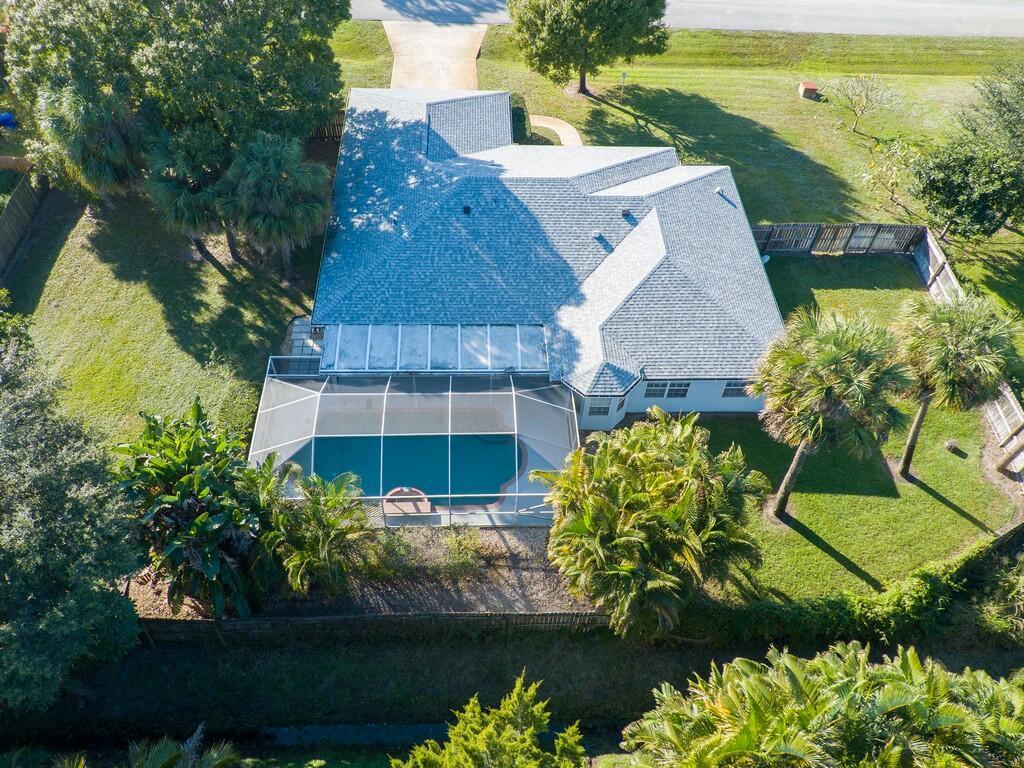 An aerial view of a house with a screened-in pool and a fenced backyard — 6130 60th Court, Vero Beach FL 32967, VERO BEACH, FL