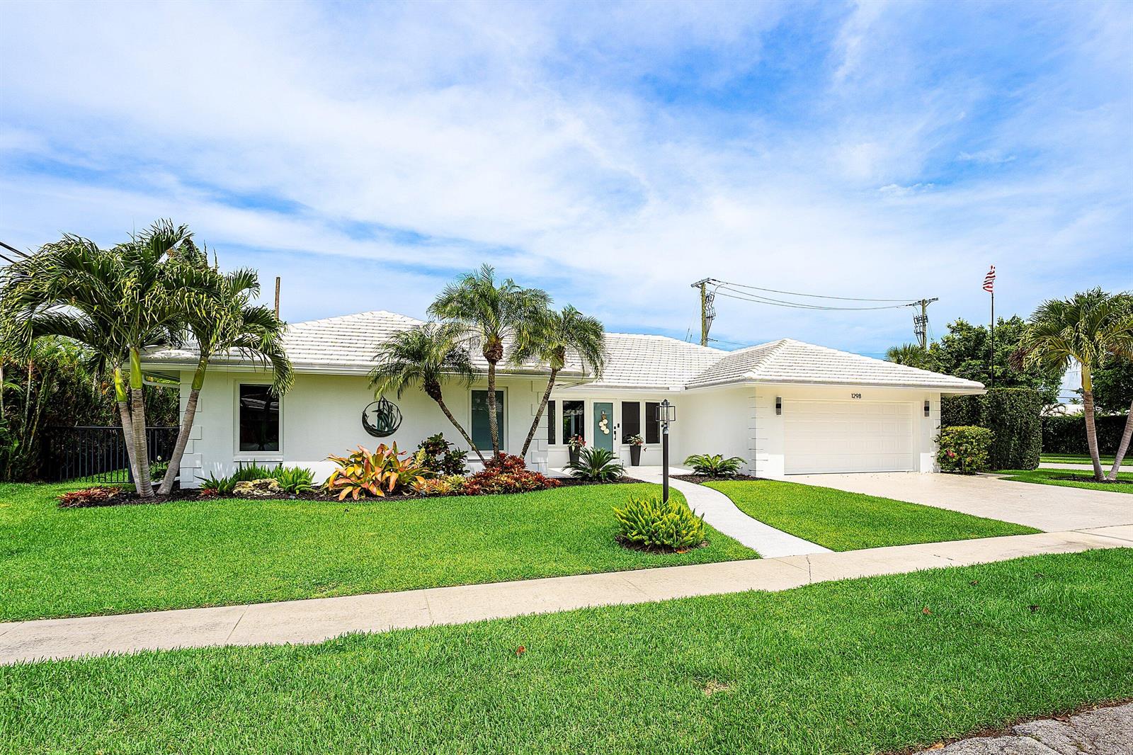 A white single-story house with a tiled roof, palm trees, and a manicured lawn — 1298 Walnut Terrace, Boca Raton FL 33486, BOCA RATON, FL