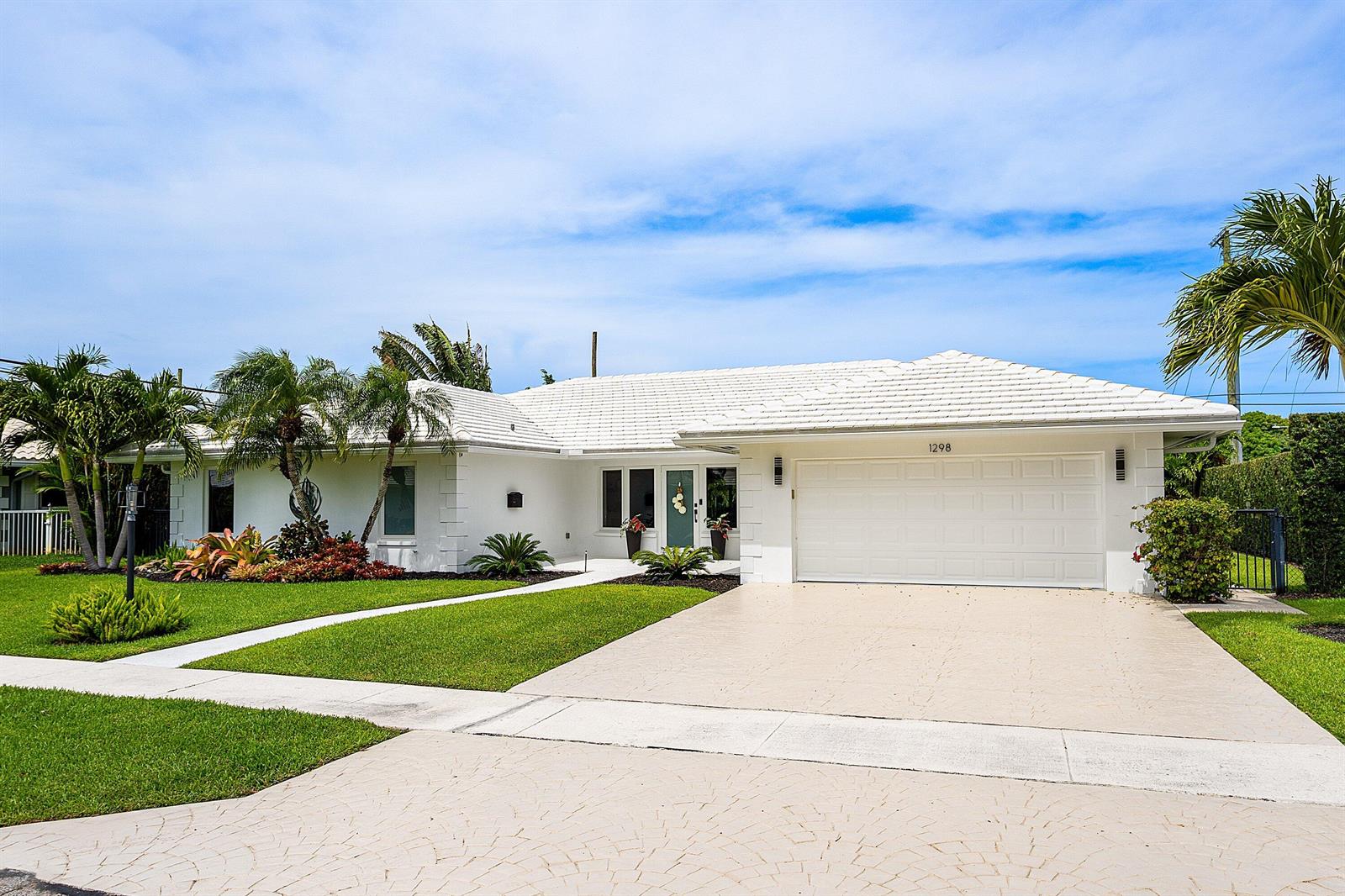A white single-story house with a tiled roof, two-car garage, and landscaped front yard — 1298 Walnut Terrace, Boca Raton FL 33486, BOCA RATON, FL