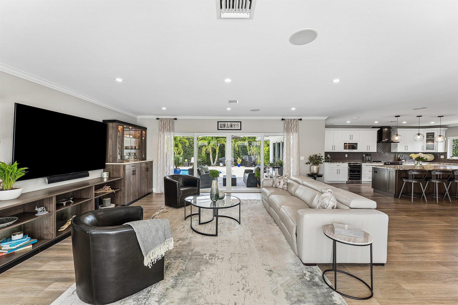 A living room with a large sofa, two armchairs, and an open-concept kitchen — 1298 Walnut Terrace, Boca Raton FL 33486, BOCA RATON, FL