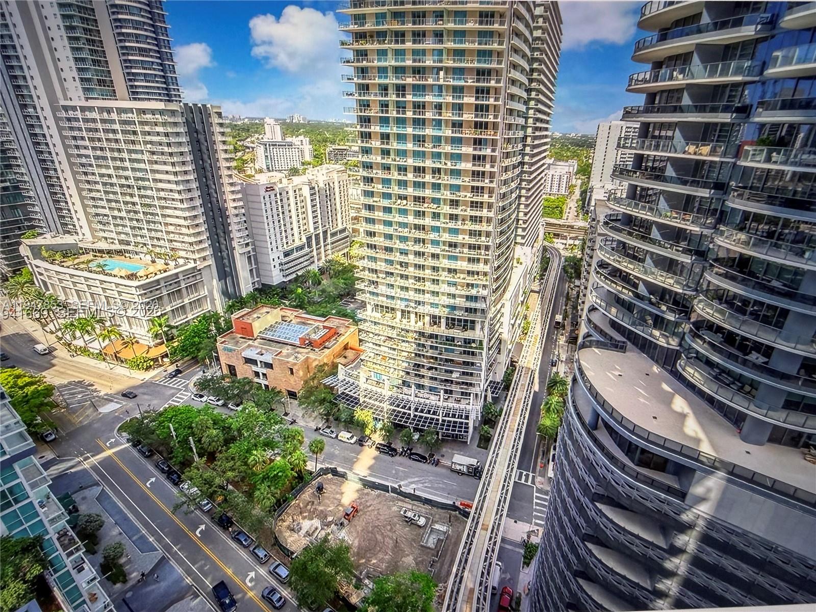 High-angle view of a city street with modern high-rise buildings and a construction site — 1050 Brickell Ave # 1816, Miami FL 33131, MIAMI, FL