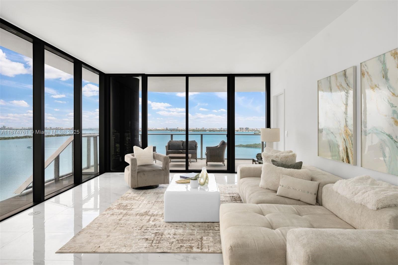 A modern living room features a white sectional sofa, a coffee table, and floor-to-ceiling windows — 700 NE 24th St # 2201, Miami FL 33137, MIAMI, FL