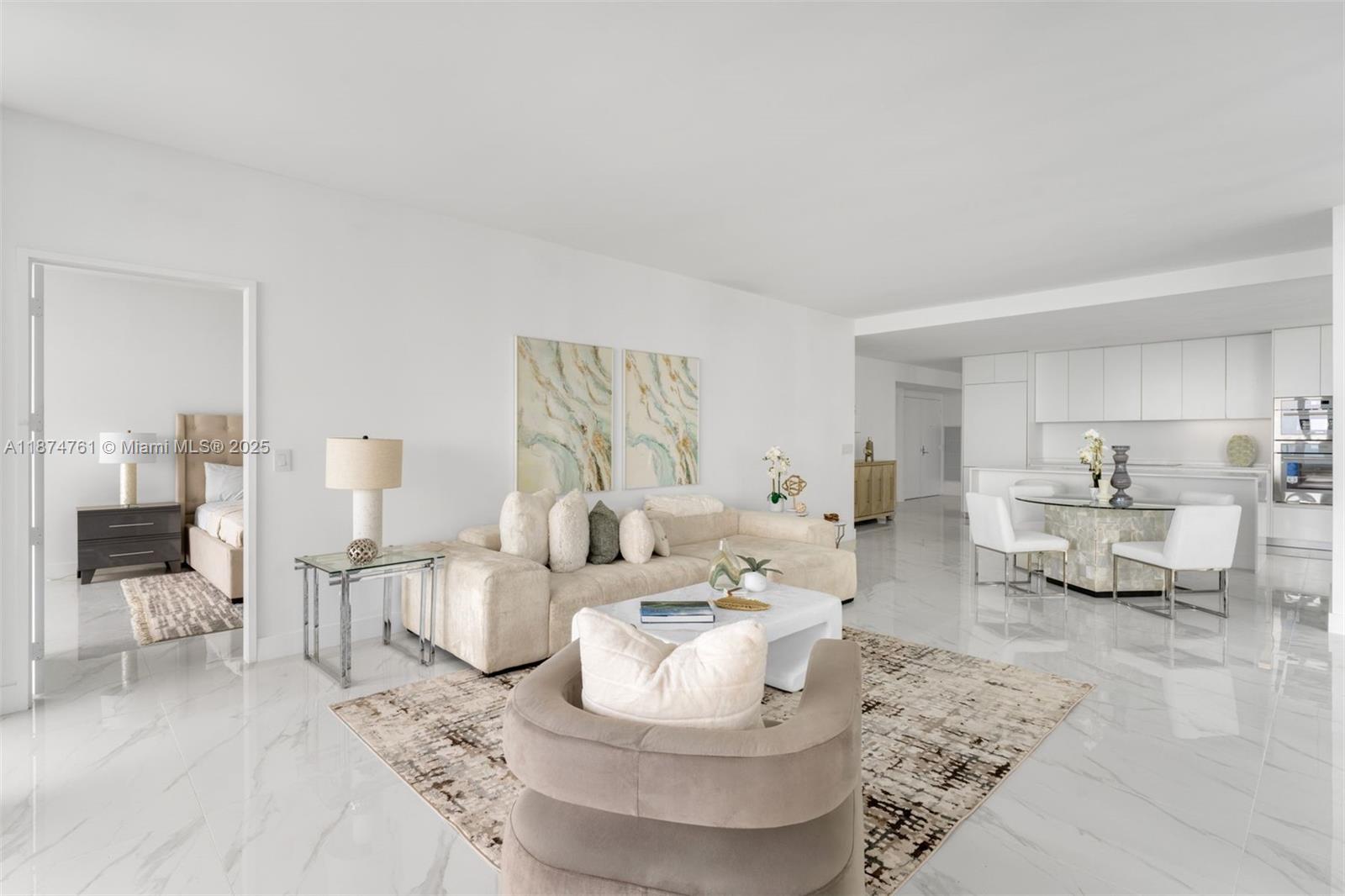 A bright, open-concept living and dining area features white marble floors and modern neutral furniture — 700 NE 24th St # 2201, Miami FL 33137, MIAMI, FL