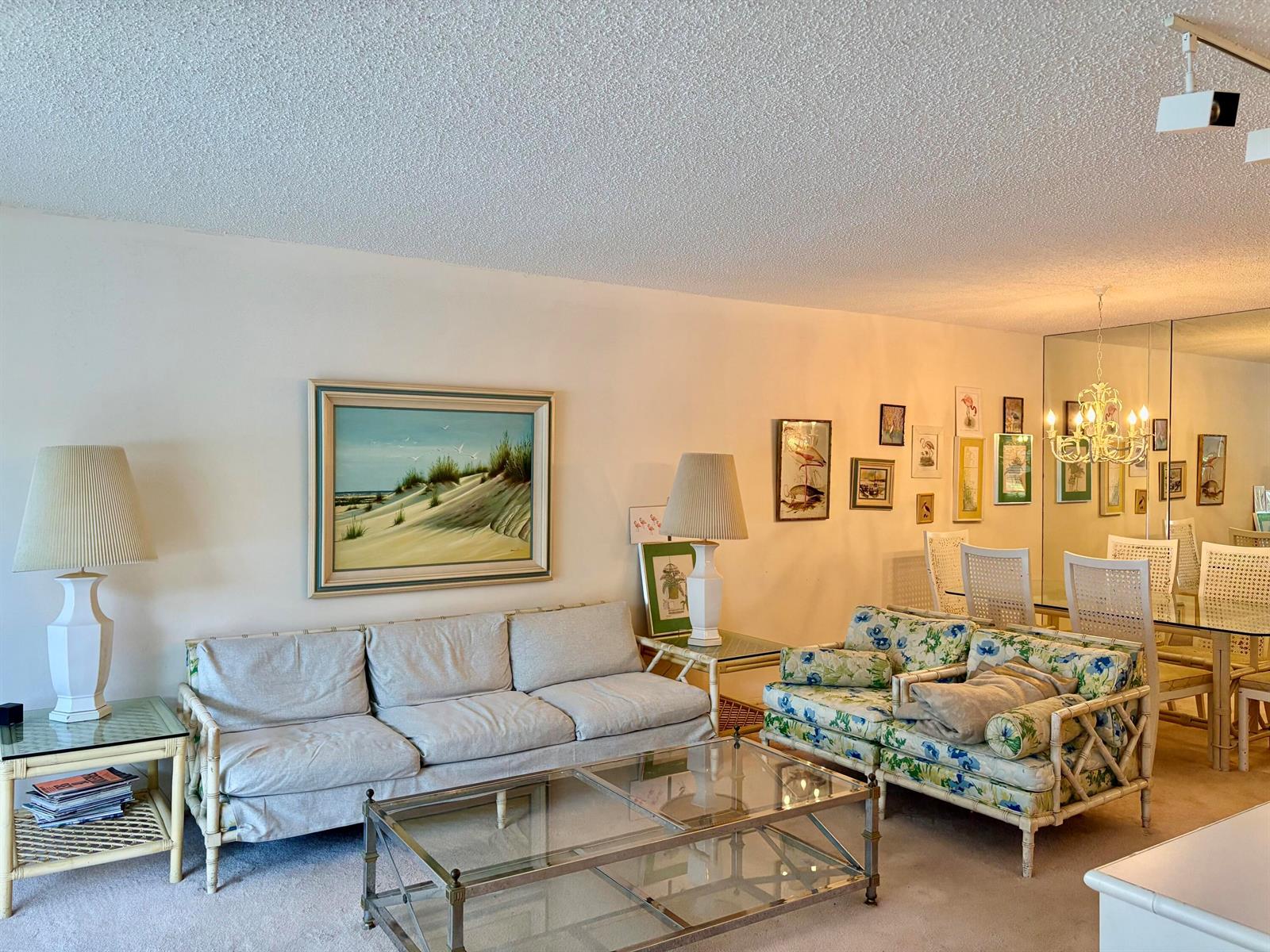 A living room features two sofas, a glass coffee table, and a dining area with mirrors — 3150 N Course Lane # 202, Pompano Beach FL 33069, POMPANO BEACH, FL