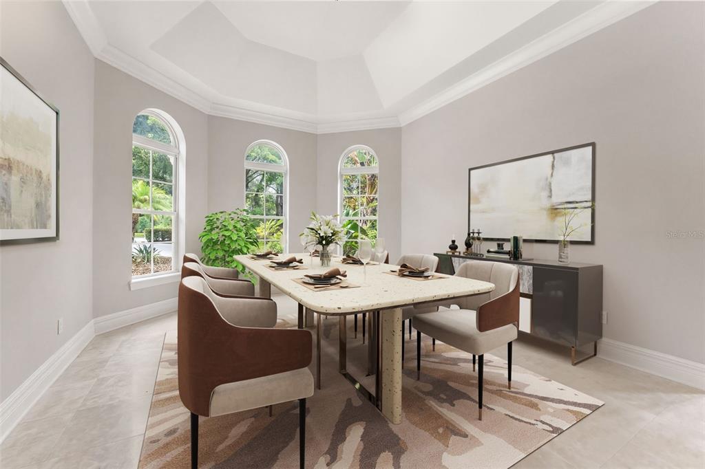 A dining room with a tray ceiling, arched windows, a stone table, and modern chairs — 18901 LAKES EDGE WAY, ODESSA, FL